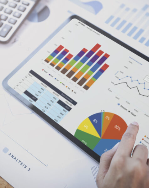 Businesswoman using a tablet to analysis graph company finance strategy statistics success concept and planning for future in office room.