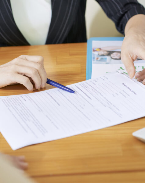 Insurance agent explaining woman what to write in contract